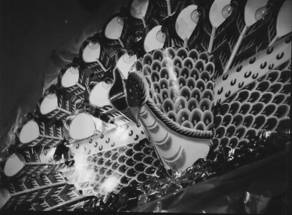 a black and white photo of a large peacock decoration display